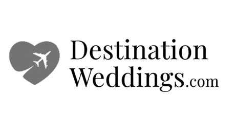 A logo featuring a heart with an airplane inside and the text "Destination Weddings.com" next to it.